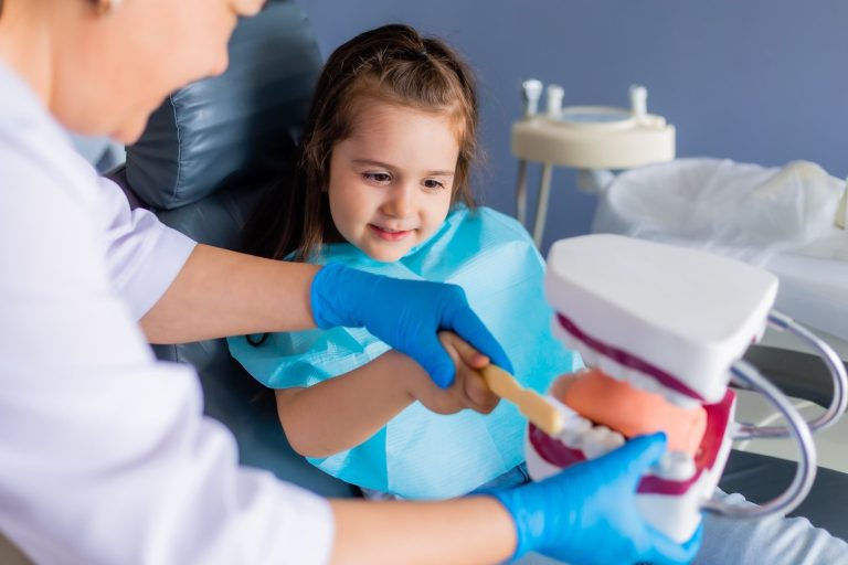 Friendly Children's Dentist with young patient