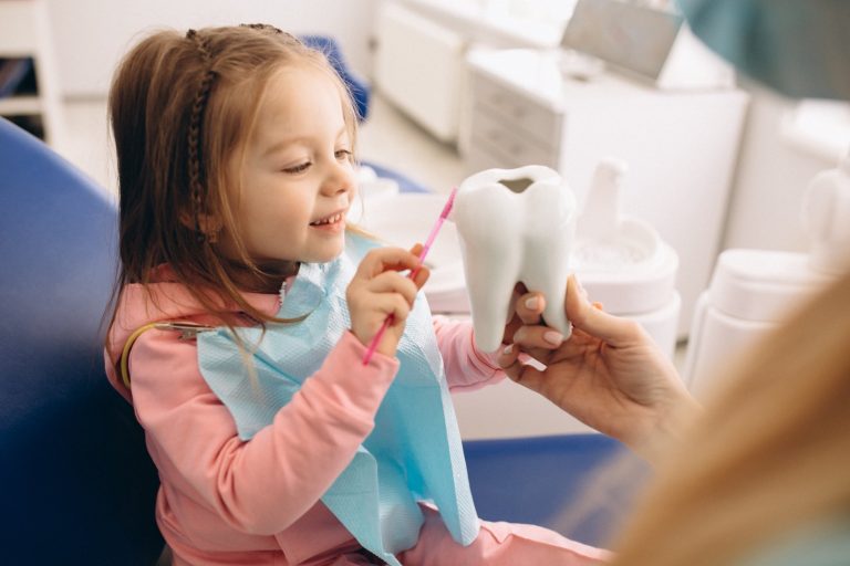 Dentist with happy child patient